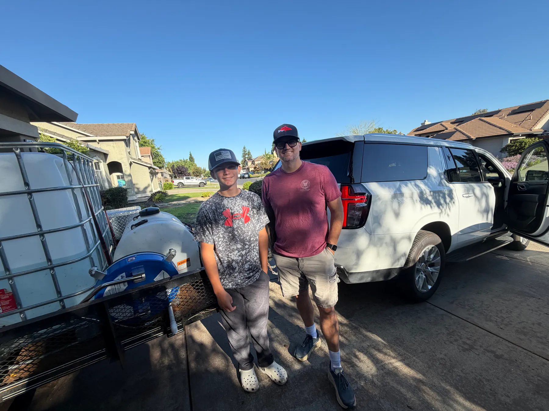 Wesley and Harrison Cable with their pressure washing rig and trailer in a Rocklin, California driveway